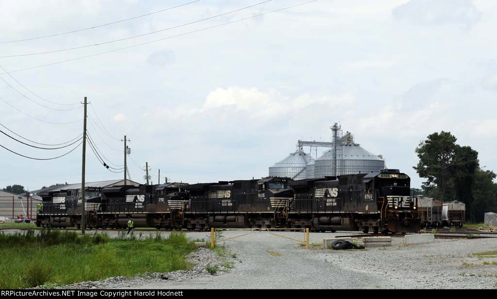 NS 8765 leads a string of locos out of a siding